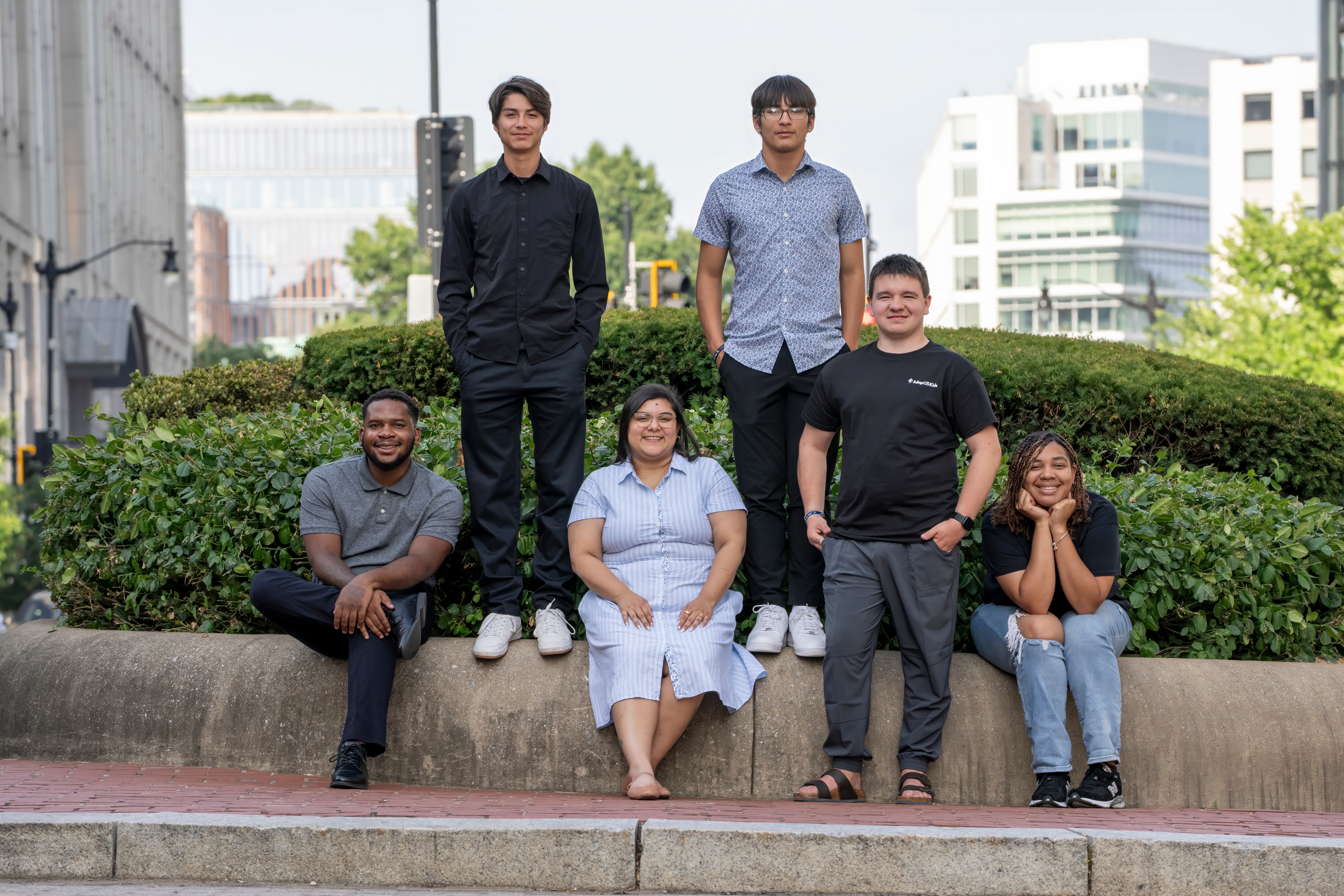group of six diverse  youth  standing and sitting for a picture