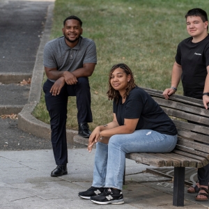 3 young adults outside taking a picture