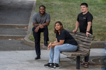 3 young adults outside taking a picture