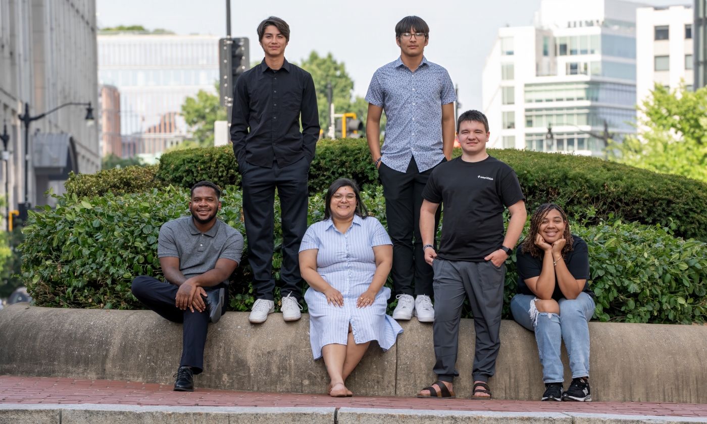 group of six diverse  youth  standing and sitting for a picture