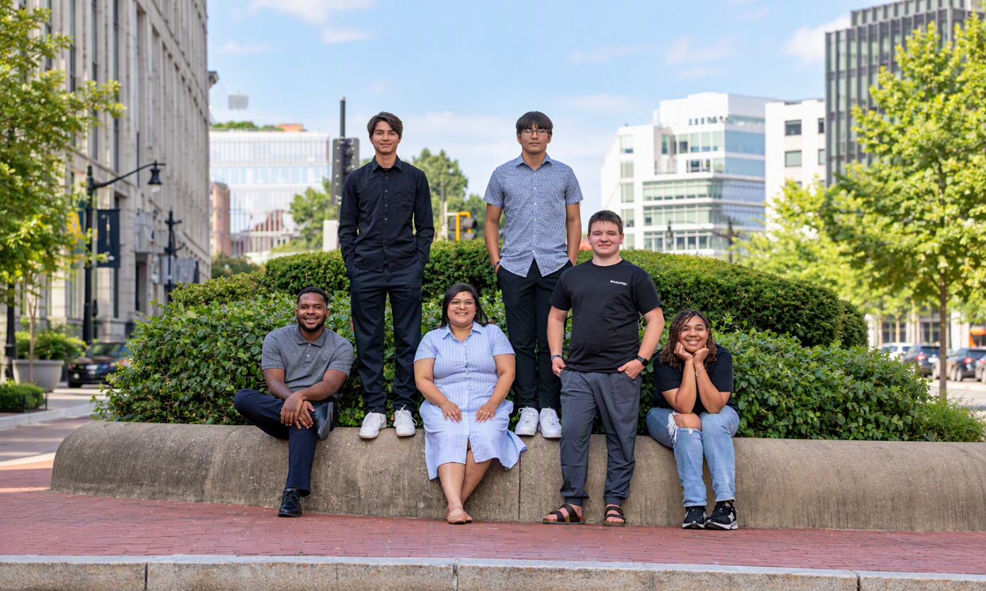 group of six diverse youth standing and sitting for a picture